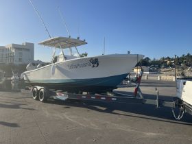 A sleek speedboat named 'Sofiamoana' is showcased on its trailer at the dock, ready for an exciting day on the water.