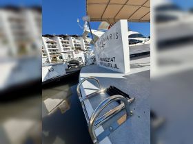 Close-up view of the stern of a boat named 'Stella Maris' docked in Puerto Vallarta, showcasing its sleek design and ladder.