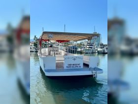 The 'Stella Maris' boat is docked in Puerto Vallarta, showcasing its spacious design and inviting atmosphere, perfect for group charters and excursions.