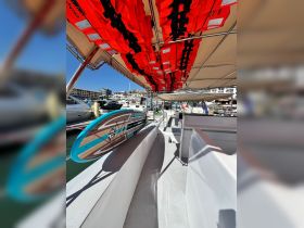 A well-equipped boat featuring a paddleboard and neatly arranged life jackets, perfect for water activities and safety on board.