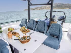 An inviting dining setup on a boat featuring a selection of gourmet food and drinks, perfect for enjoying a meal while cruising on the water.