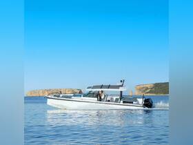 A stylish boat navigates through calm waters, showcasing a scenic backdrop — perfect for exploring coastal destinations.