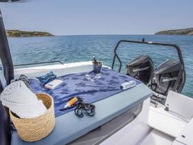 A well-arranged setup on a boat featuring towels, snorkel gear, and refreshments, perfect for a day of relaxation and water activities.