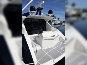 A sleek interior view of a yacht's helm area, showcasing modern seating and design elements, perfect for luxury boating experiences.