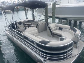 Interior view of a stylish pontoon boat featuring comfortable seating and a sleek design, perfect for relaxing on the water.