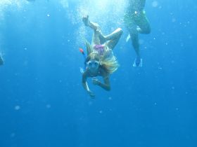A child enjoys snorkeling underwater, showcasing the vibrant marine life and the excitement of aquatic adventures — perfect for family outings and ocean exploration.