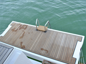 A close-up view of a boat deck showcasing its sleek design and clean lines, perfect for lounging and enjoying the water.