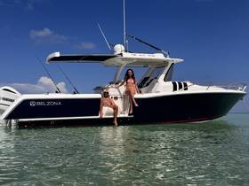 A couple enjoys a sunny day on the water, relaxing on their Belzona boat — perfect for summer adventures and aquatic fun.