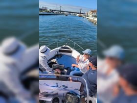 A group enjoys a lively conversation aboard a boat, navigating through scenic waters — perfect for memorable outings and shared experiences.