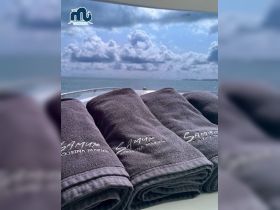 A set of neatly arranged towels on a boat, perfect for relaxing under the sun while enjoying the serene ocean views.