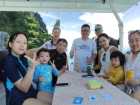 A joyful family celebration aboard a boat, featuring a birthday cake and smiles all around — perfect for memorable gatherings on the water.