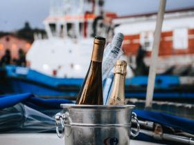 Chilled champagne bottles in a bucket, perfect for celebrating special moments on the water. Ideal for luxury boat charters and sunset cruises.