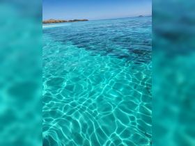 A serene view of crystal-clear turquoise waters, showcasing the beauty of the ocean. Ideal for beachgoers and nature lovers.