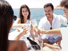 A group of friends toasting with champagne glasses aboard a yacht, capturing the essence of celebration and good times on the water.
