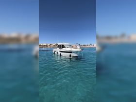 A picturesque view of a boat anchored in clear turquoise waters, showcasing the perfect setting for a relaxing day on the water.