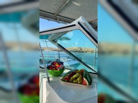 A vibrant display of fresh fruit and snacks on board, perfect for enjoying while cruising the waters. Ideal for catering on boat trips.