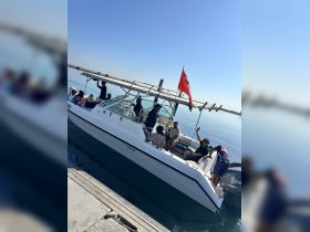 A lively group enjoys a day on the water aboard a boat, showcasing the fun and camaraderie of a boating experience.