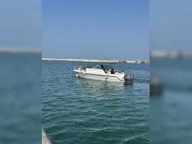 A lively group enjoys a day on the water aboard a boat, showcasing the fun and camaraderie of on-water activities.