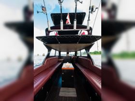 Interior view of a stylish boat cabin featuring comfortable seating and a well-equipped helm, perfect for relaxing and enjoying the journey on the water.