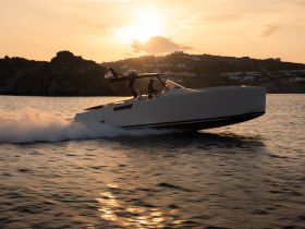 A sleek boat speeds across the water at sunset, creating a stunning scene perfect for adventure seekers and sunset cruises.
