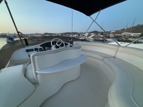 A well-appointed helm area of a boat, showcasing comfortable seating and control features, perfect for navigating the waters.
