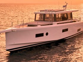 A stunning yacht glides through calm waters during sunset, showcasing its sleek design and elegance — perfect for luxury charters and sunset cruises.