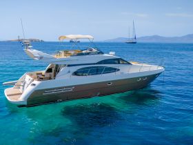 A stunning aerial view of a luxurious yacht cruising through crystal-clear waters, perfect for upscale charters and island adventures.