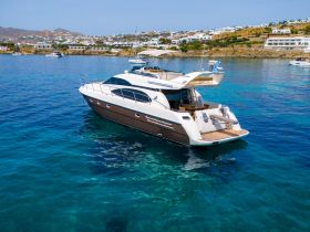 A stunning yacht anchored in crystal-clear waters, showcasing its elegant design against a picturesque coastal backdrop.