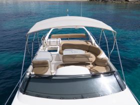 A spacious and inviting interior view of a boat's lounge area, featuring comfortable seating and a sleek design, perfect for relaxing on the water.