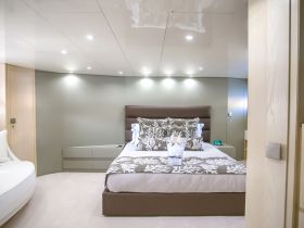 A beautifully designed boat cabin featuring a cozy bedroom with elegant decor and modern amenities, perfect for a luxurious stay on the water.