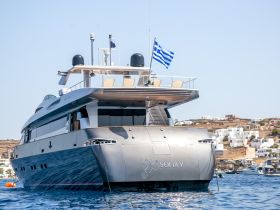 A stunning view of the yacht 'Sofia Y' docked in clear waters, showcasing its elegant design against a picturesque coastal backdrop.