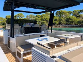A stylish interior view of a modern yacht's helm and seating area, showcasing a perfect blend of comfort and functionality for an enjoyable boating experience.