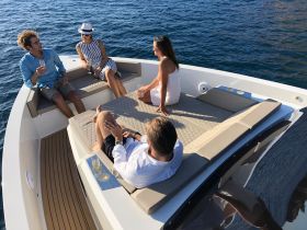 A lively group enjoys cocktails on the deck of a boat, perfect for socializing and celebrating special moments on the water.