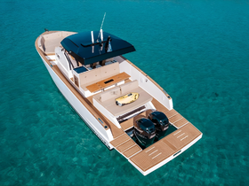 A stunning aerial view of a luxurious yacht cruising through crystal-clear waters, showcasing its sleek design and spacious deck, perfect for upscale boating experiences.