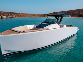 A sleek speedboat glides through crystal-clear waters, showcasing its modern design and elegant lines — perfect for luxury outings on the water.