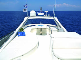 A pristine view of the interior seating area on a yacht, showcasing a stylish helm and inviting lounge space, perfect for relaxing while cruising on the open water.