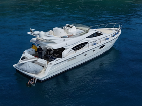 A person enjoys a refreshing swim while others are on the deck of a luxurious yacht, showcasing the perfect blend of relaxation and adventure on the water.