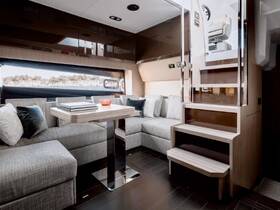 A stylish interior view of a boat's cabin featuring comfortable seating and a modern helm area, perfect for relaxing or navigating on the water.