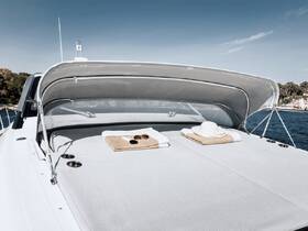 A serene view of the lounge area on a yacht, featuring plush towels and a sun hat, perfect for relaxing under the sun while enjoying the open water.