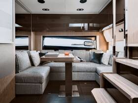A stylish and modern interior of a boat featuring a cozy seating area and dining table, perfect for relaxing and enjoying meals while on the water.