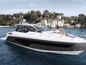 A couple enjoys sunbathing on the deck of a sleek yacht, surrounded by stunning coastal scenery — perfect for romantic getaways or leisurely days on the water.