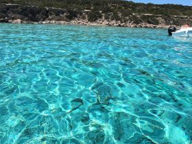 A serene view of crystal-clear turquoise waters, showcasing the beauty of the underwater landscape. The image captures the essence of a tranquil boating experience.