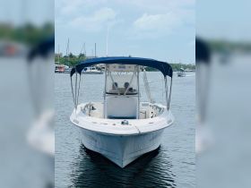 A front view of a center console boat docked in calm waters, showcasing its sleek design and inviting atmosphere for a day on the water.