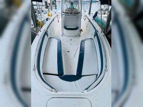 The interior of a boat featuring spacious seating and a helm area, perfect for comfortable cruising and relaxation on the water.