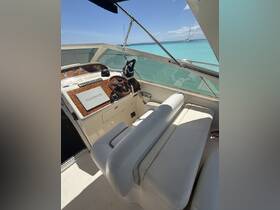 A well-appointed helm area of a yacht featuring a Garmin navigation system and comfortable seating, perfect for steering through turquoise waters.