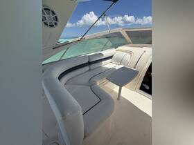 A spacious and inviting lounge area inside a boat, featuring comfortable seating and a table, perfect for relaxing while enjoying the beautiful views of the water.
