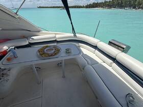 A cozy interior view of a boat's lounge area, featuring comfortable seating and snacks, perfect for relaxing while enjoying the turquoise waters.