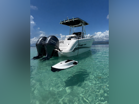 A sleek Pro-Line speedboat anchored in crystal clear waters, showcasing its powerful Yamaha engines — perfect for thrilling adventures on the water.