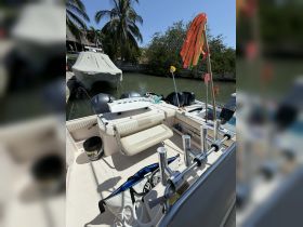 An interior view of a boat showcasing the seating and helm area, perfect for fishing or leisure outings on the water.