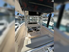 A well-equipped helm area of a boat, showcasing the seating and console, perfect for navigating the waters in style and comfort.